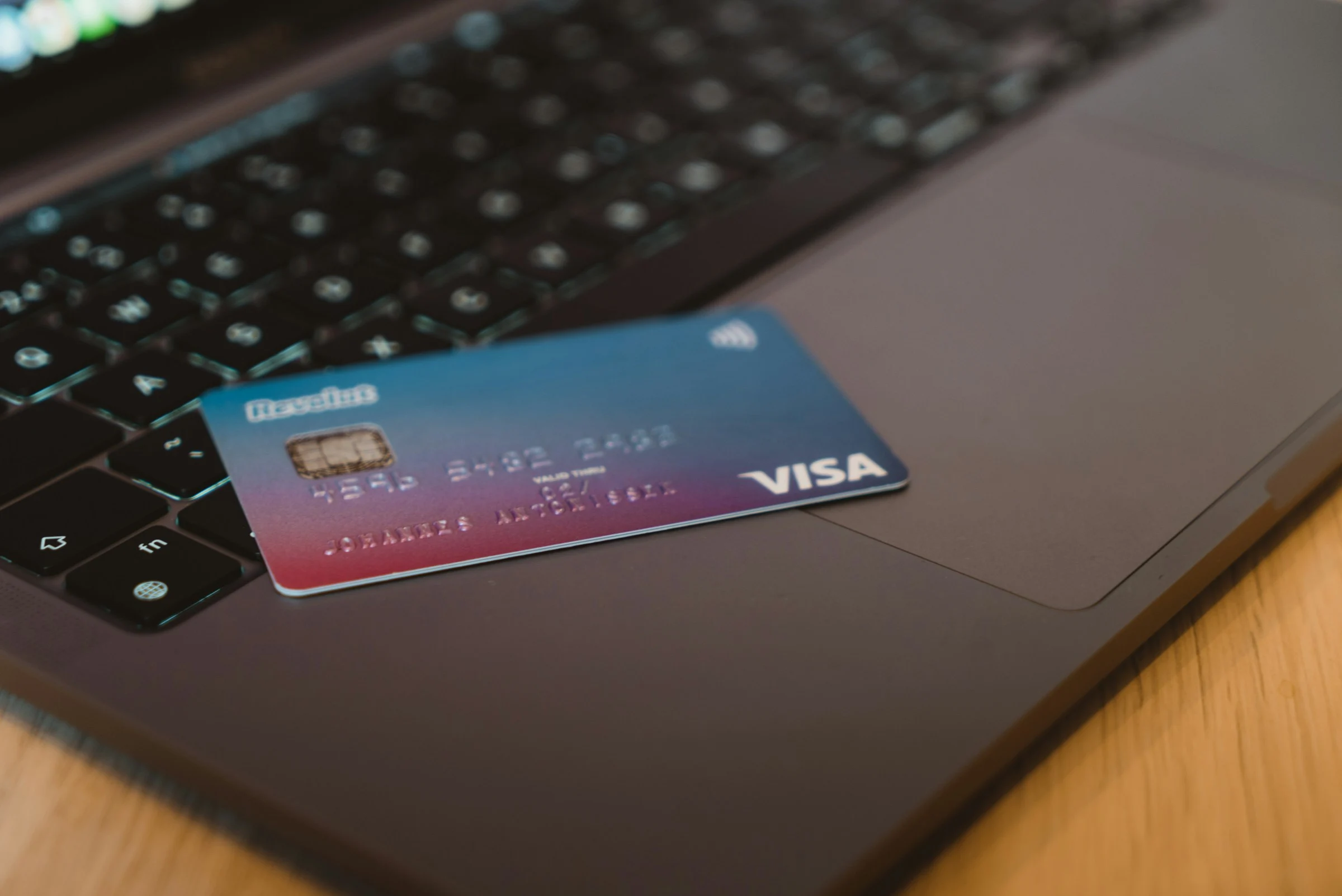 Visa card on silver laptop